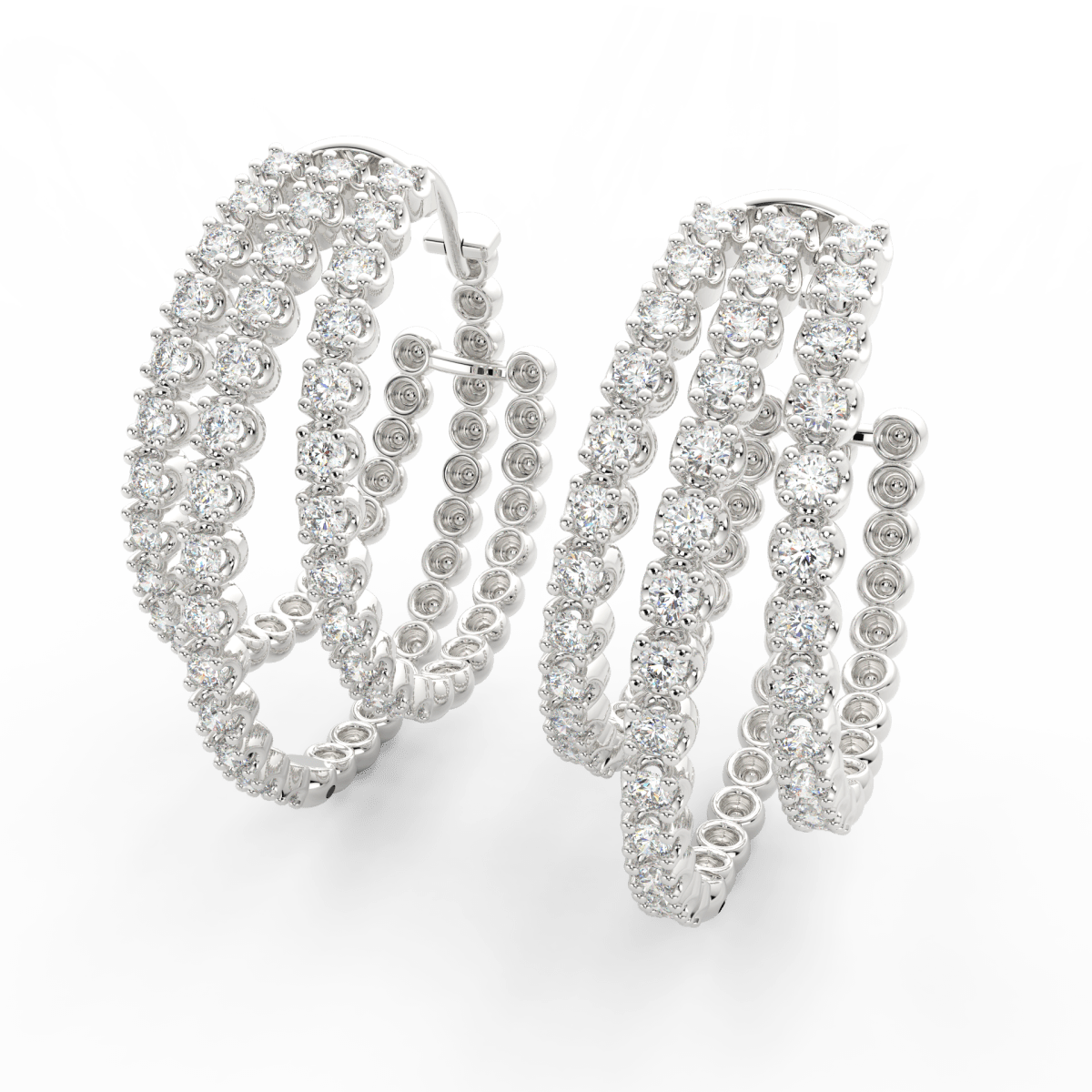 Angled view of white gold triple hoop earrings showcasing layered lab grown diamonds with polished finish.
