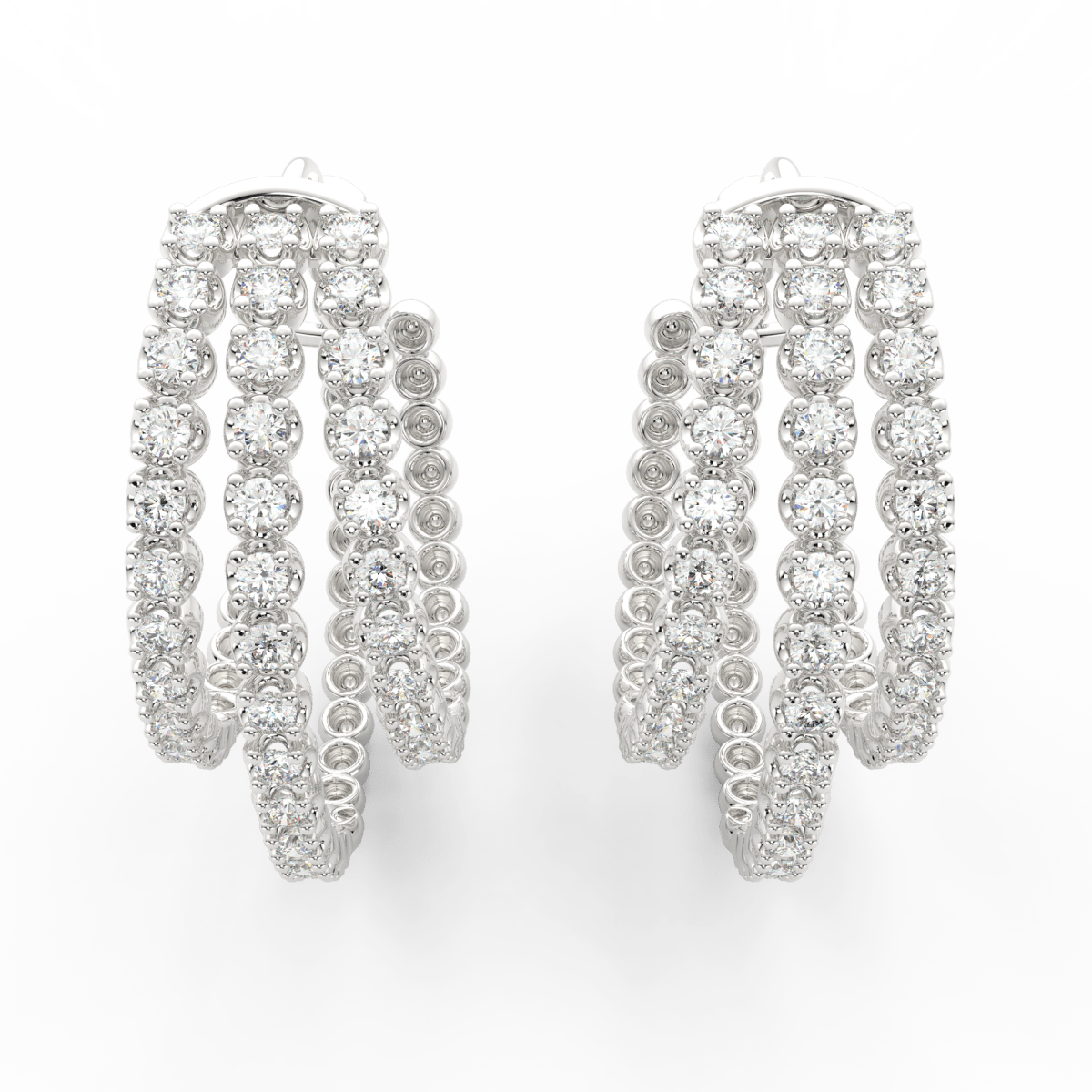 Top view of white gold hoops highlighting lab grown diamonds arranged on multi-layered hoops.
