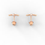 Overhead view showing round rose gold earrings with SGL certified lab grown diamonds.

