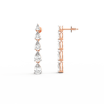 Side profile of rose gold earrings with hook closure and lightweight curved drop structure.
