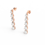 Top view of rose gold drop earrings showing gentle curve and brilliant lab grown diamond sparkle.
