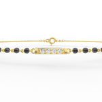 Front view of Eternal Noir yellow gold mangalsutra bracelet featuring lab grown diamonds with black bead accents.
