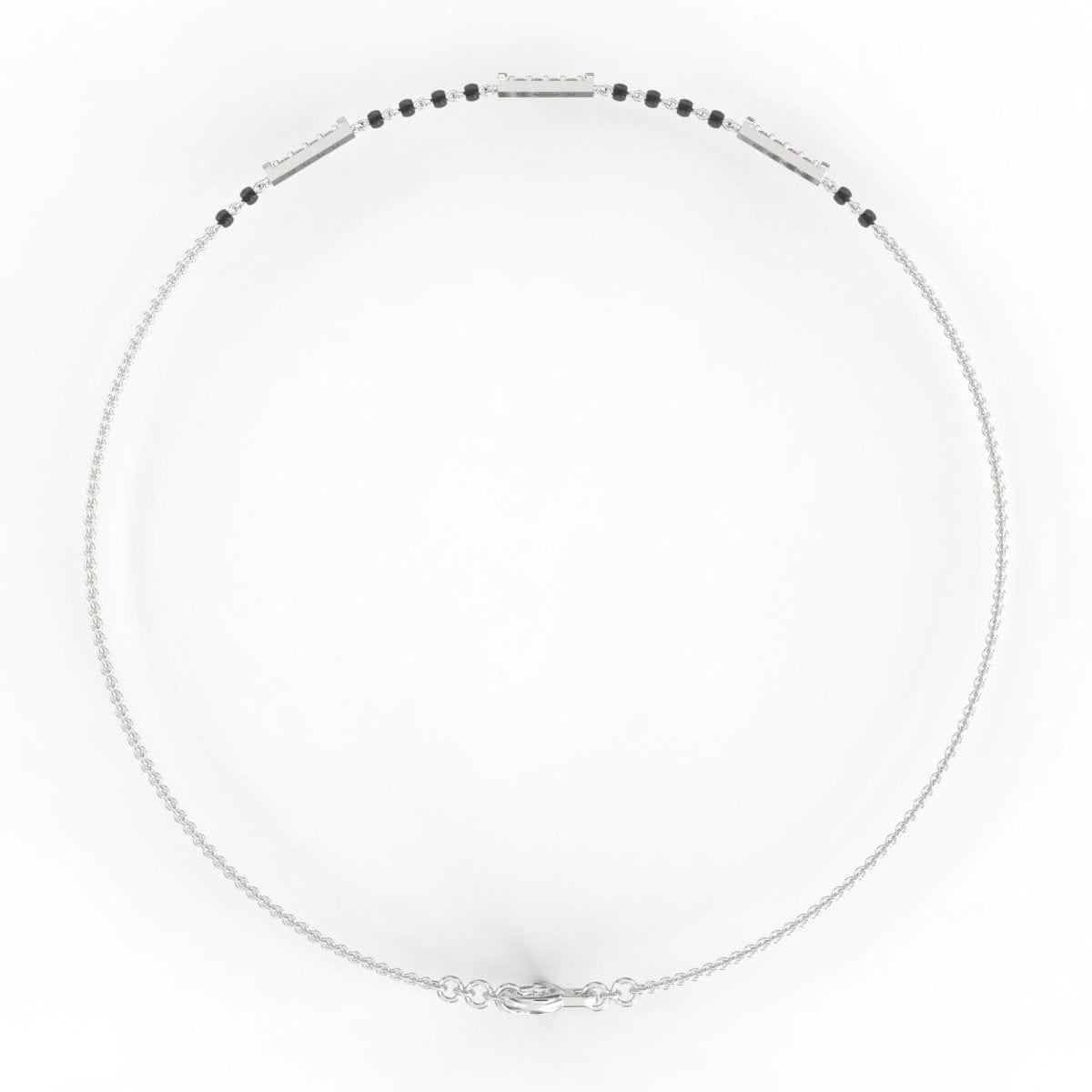 Top view of white gold mangalsutra bracelet highlighting polished diamond setting and black bead pattern.
