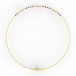 Top view of yellow gold Eternal Noir mangalsutra bracelet with sparkling lab grown diamonds and minimal black beads.
