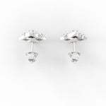 Overhead view of minimalist white gold studs with gleaming lab grown diamonds at the center.

