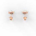 Overhead shot of petite rose gold diamond earrings with minimalist round bezel setting.

