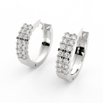Angled view of white gold channel hoop earrings featuring brilliant lab grown diamonds and smooth polished surface.
