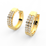 Angled view of yellow gold Lumière hoop earrings featuring channel set lab grown diamonds and smooth finish.
