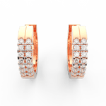 Top view of rose gold hoops highlighting channel set lab grown diamonds placed along the polished oval frame.
