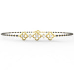 Yellow Gold: Close-up of Obsidian Glamour yellow gold mangalsutra bracelet highlighting polished gold links with alternating lab grown diamonds and black beads.

