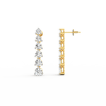 Side profile of yellow gold diamond drop earrings with secure hook clasp and graceful cascading silhouette.
