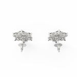 Top-down view of minimalist white gold earrings set with a central sparkling diamond.
