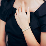 Model showcasing rose gold bracelet with oval diamonds, styled for elegance and ease.
